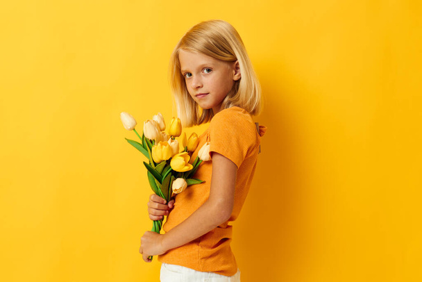 cheerful girl with a bouquet of flowers fun gift holiday - Фото, зображення