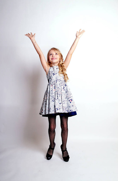Pretty young kid girl  in grey dress.Isolated studio shot - Foto, afbeelding