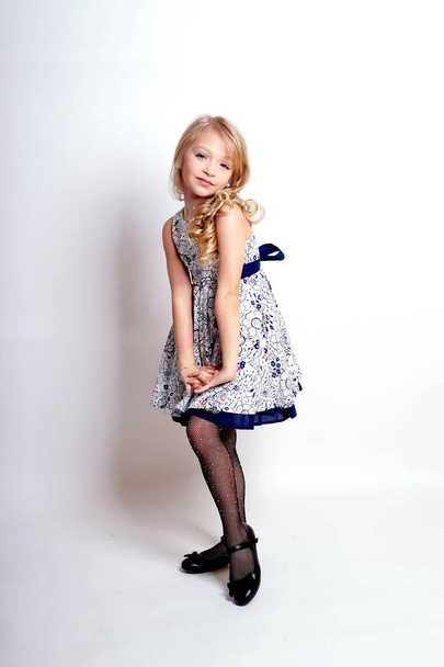Pretty young kid girl  in grey dress.Isolated studio shot - Foto, Imagen