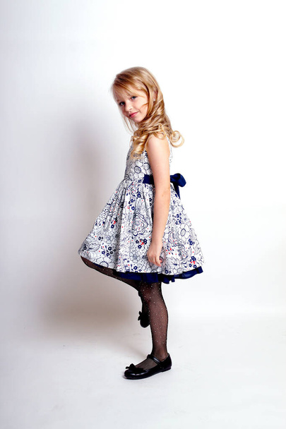 Pretty young kid girl  in grey dress.Isolated studio shot - Φωτογραφία, εικόνα