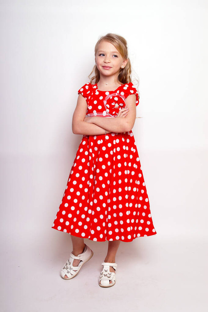 Pretty young kid girl  in red dress with gift box.Isolated studio shot - Fotografie, Obrázek