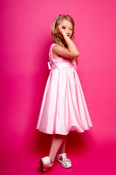 Pretty young kid girl  in pink dress.Isolated studio shot - Photo, Image