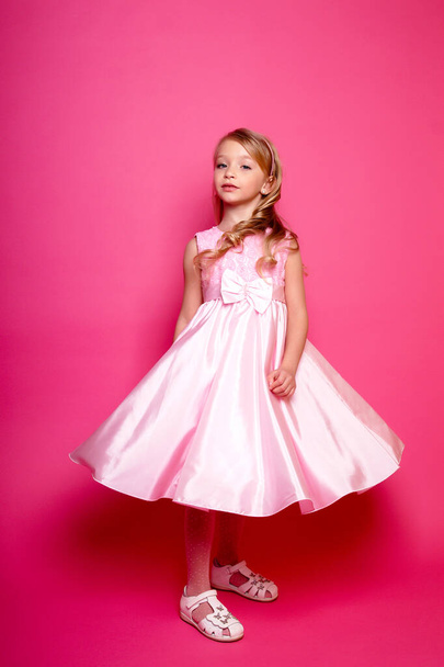 Pretty young kid girl  in pink dress.Isolated studio shot - Foto, Imagem