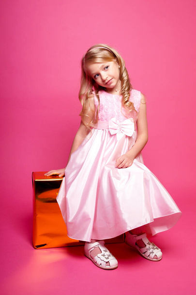 Pretty young kid girl  in pink dress.Isolated studio shot - Zdjęcie, obraz