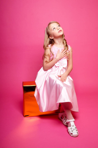 Pretty young kid girl  in pink dress.Isolated studio shot - Photo, image