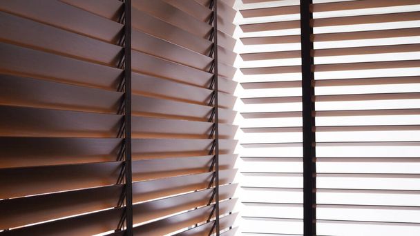 Brown wooden blinds on windows of rooms inside house. - Photo, Image