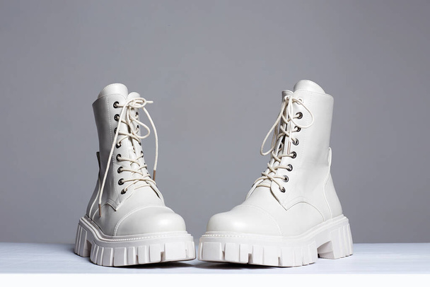 white boots. fashion shoes still life. stylish photo in the studio - Fotografie, Obrázek