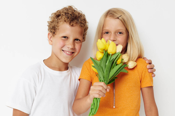 Portrait of cute children holiday friendship with a gift Yellow flowers lifestyle unaltered - Foto, Imagem