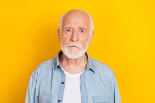 Portrait of attractive serious grey-haired man wearing cozy shirt isolated over vibrant yellow color background - Fotó, kép