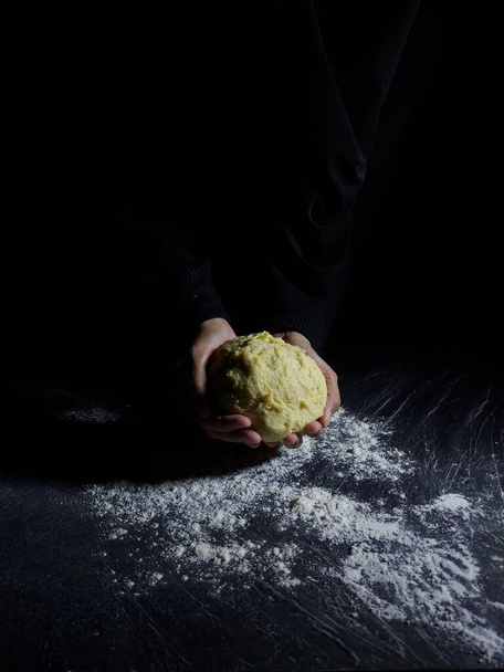 Women hand makes flour dough. Baking story photography. Dark mood. - Photo, Image