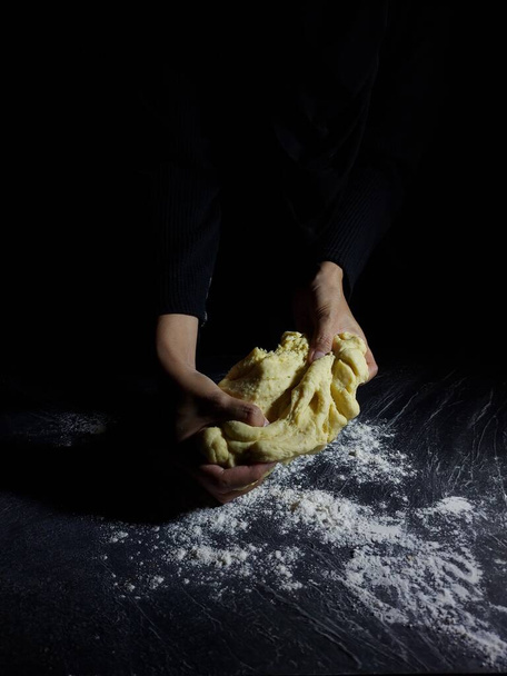Women hand makes flour dough. Baking story photography. Dark mood. - Foto, Imagem