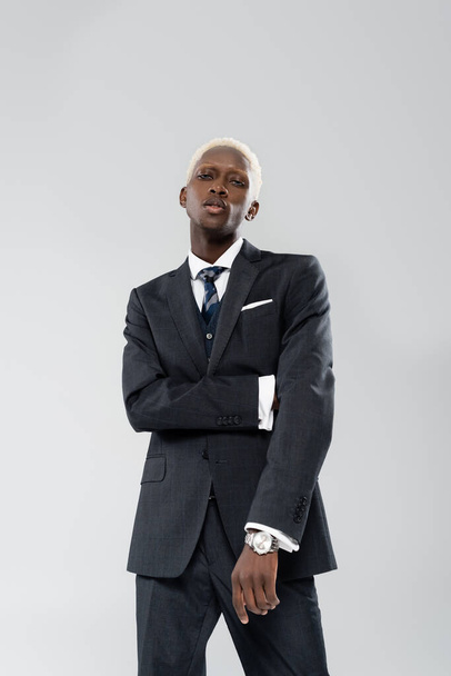 blonde african american businessman in suit posing isolated on grey - Fotoğraf, Görsel
