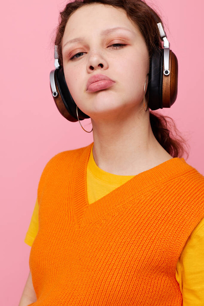 cheerful woman grimace headphones entertainment emotions music pink background unaltered - Foto, Imagen