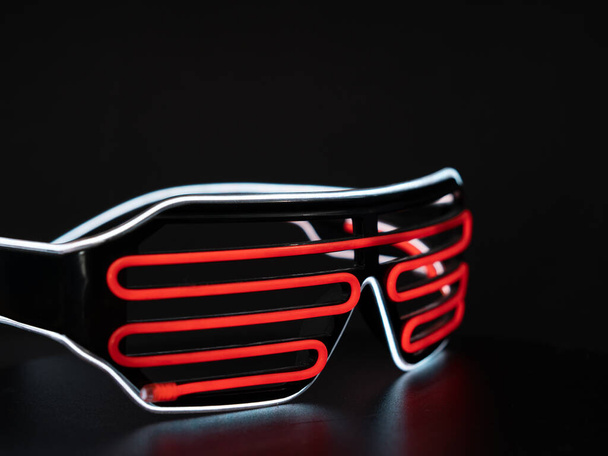 Glowing neon LED glasses. Carnival luminous glasses. Glow in the dark glasses for club, party. - Photo, Image