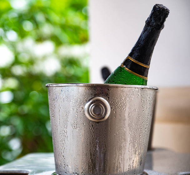 closed bottle of sparkling wine in ice buckets - Photo, image