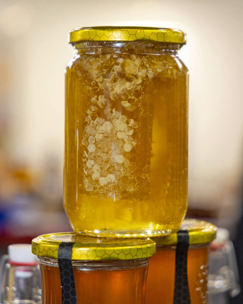 Raw Natural Organic Honey With Honeycomb in Glass Jar - Fotó, kép
