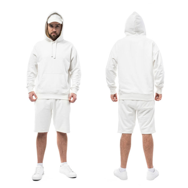 Handsome man wearing blank white cap, hoodie and shorts isolated on white background - Foto, Bild