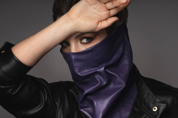 New normal fashion after virus pandemic. Portrait of stylish woman wearing leather neck gaiter instead of prevention mask. - Foto, Bild