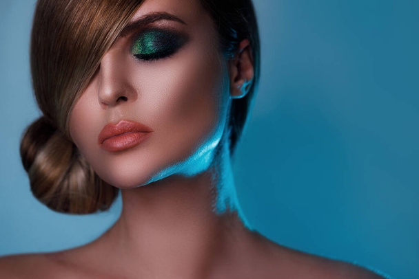 Sexy model in stylish image with sleek hair covering one eye and beautiful green eyeshadows on another - Photo, image