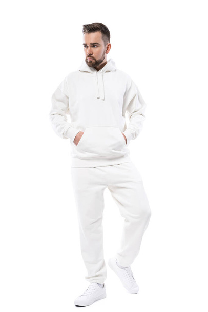 Handsome man wearing blank white hoodie and pants isolated on white background - Foto, Imagem