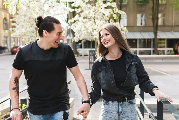 Portrait of happy laughing couple having fun during their date on a city street - Photo, Image