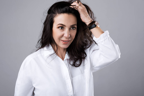Portrait of beautiful middle aged woman wearing white shirt  in photo studio - Zdjęcie, obraz