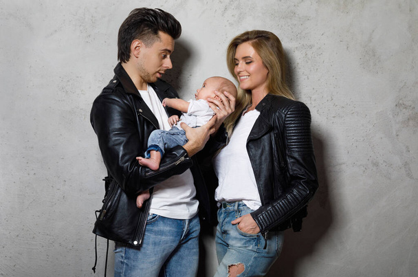 Young and stylish family. Happy mother and father with little baby boy. - Zdjęcie, obraz