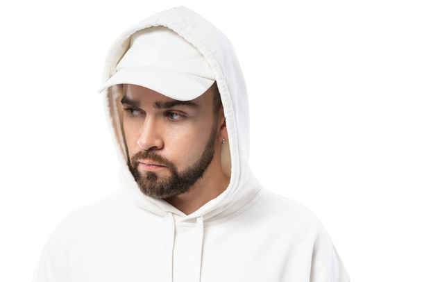 Handsome man wearing blank white cap and hoodie isolated on white background - Valokuva, kuva