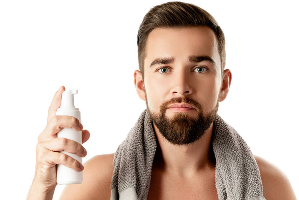 Handsome man with a cleansing or shaving foam on white background - Фото, зображення