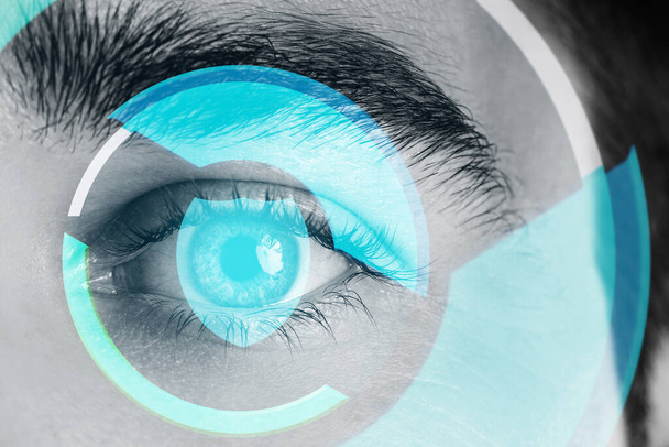 Close-up of male eye with HUD display. Concepts of augmented reality and biometric iris recognition or visual acuity check-up - Fotografie, Obrázek