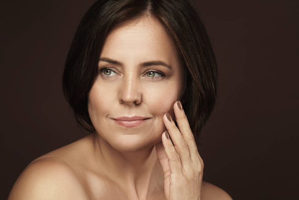 Portrait of a beautiful middle aged woman with clean wrinkled skin - 写真・画像