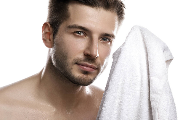 Portrait of young handsome man with wet face after shower on white background - Foto, Imagem