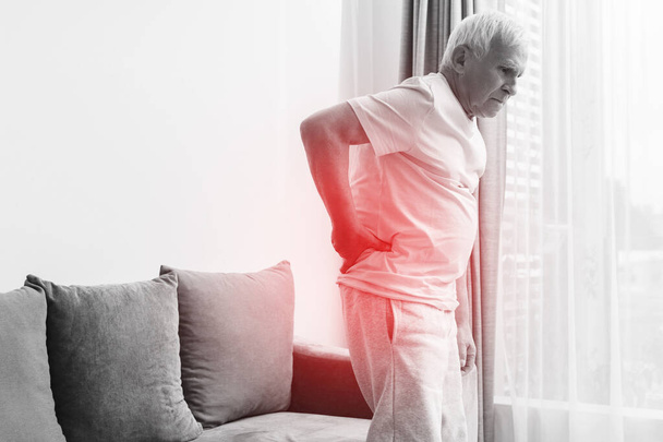 Senior man is suffering from pain in lower back at home - Φωτογραφία, εικόνα