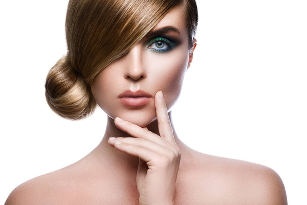 Sexy model in stylish image with sleek hair covering one eye and beautiful green eyeshadows on another against white background - Foto, Imagen