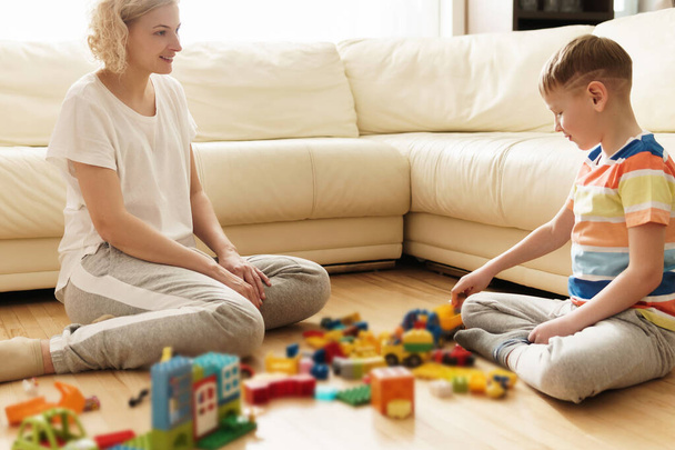 Cute boy and his happy mother playing together at home - Fotoğraf, Görsel