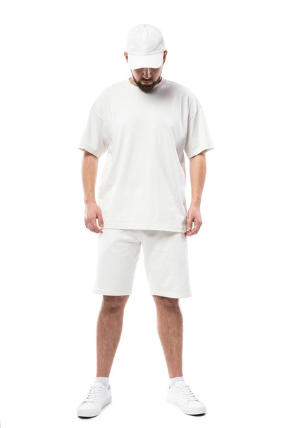 Handsome man wearing blank white cap, t-shirt and shorts isolated on white background - Foto, Imagem