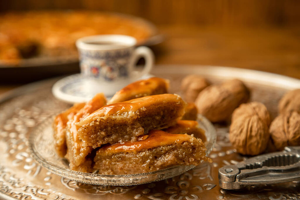 Baklava with nuts on a wooden background. Selective focus. food and drink. - Photo, Image