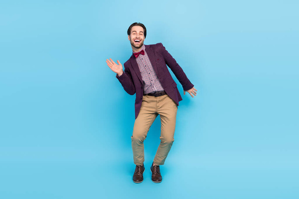 Full size photo of young excited man good mood dancing date performance isolated over blue color background - Fotoğraf, Görsel