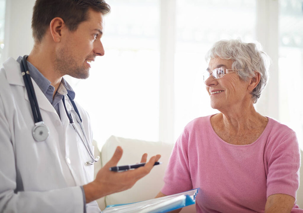 Youre in good health. Shot of a male doctor explaining something to his senior patient. - Foto, Imagen