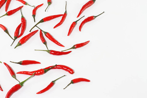 Bunch of raw fresh red chili pepper on white - Fotó, kép