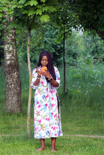 A young black pretty girl from Africa with a mobile phone - Valokuva, kuva