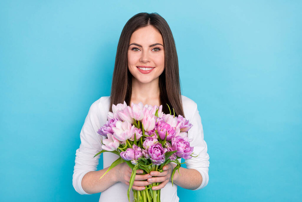 Photo of adorable charming good mood woman receive butch of flowers on her birthday isolated on blue color background - Foto, Imagem
