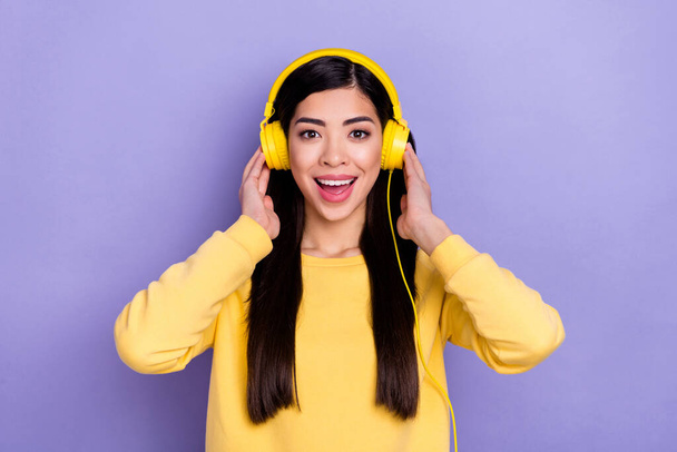 Photo of young excited girl listen playlist melody earphones wow unexpected reaction isolated over purple color background - Φωτογραφία, εικόνα