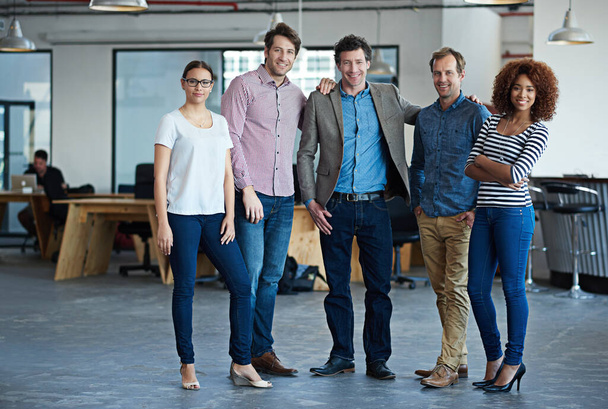 Were one amazing team. Portrait of a group of colleagues standing in a modern office. - Foto, Imagem