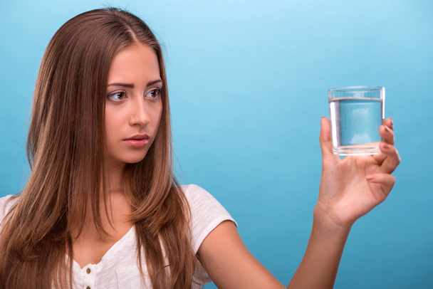 Girl holding a glass with clean water - Foto, imagen