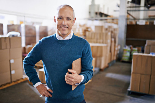 Tracking your shipment from start to finish. Portrait of a mature man standing in a distribution warehouse. - Fotografie, Obrázek