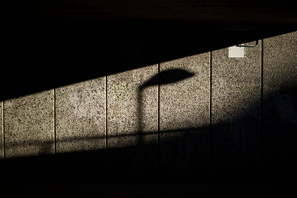 Stockholm, Sweden The shadow of a street lamp in an underground passage in the Arsta suburb. - Photo, Image