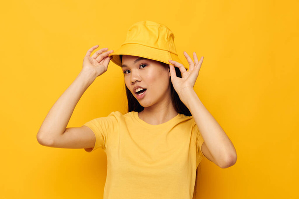 pretty brunette wearing a yellow hat posing emotions studio model unaltered - Zdjęcie, obraz