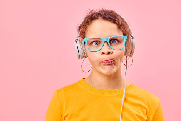 funny girl yellow t-shirt headphones entertainment music fun pink background unaltered - Photo, image