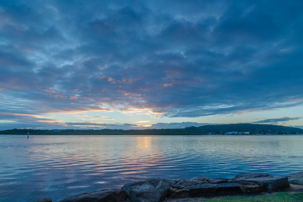 Cloudy sunrise waterscape at Woy Woy on the Central Coast, NSW, Australia. - Foto, Imagen